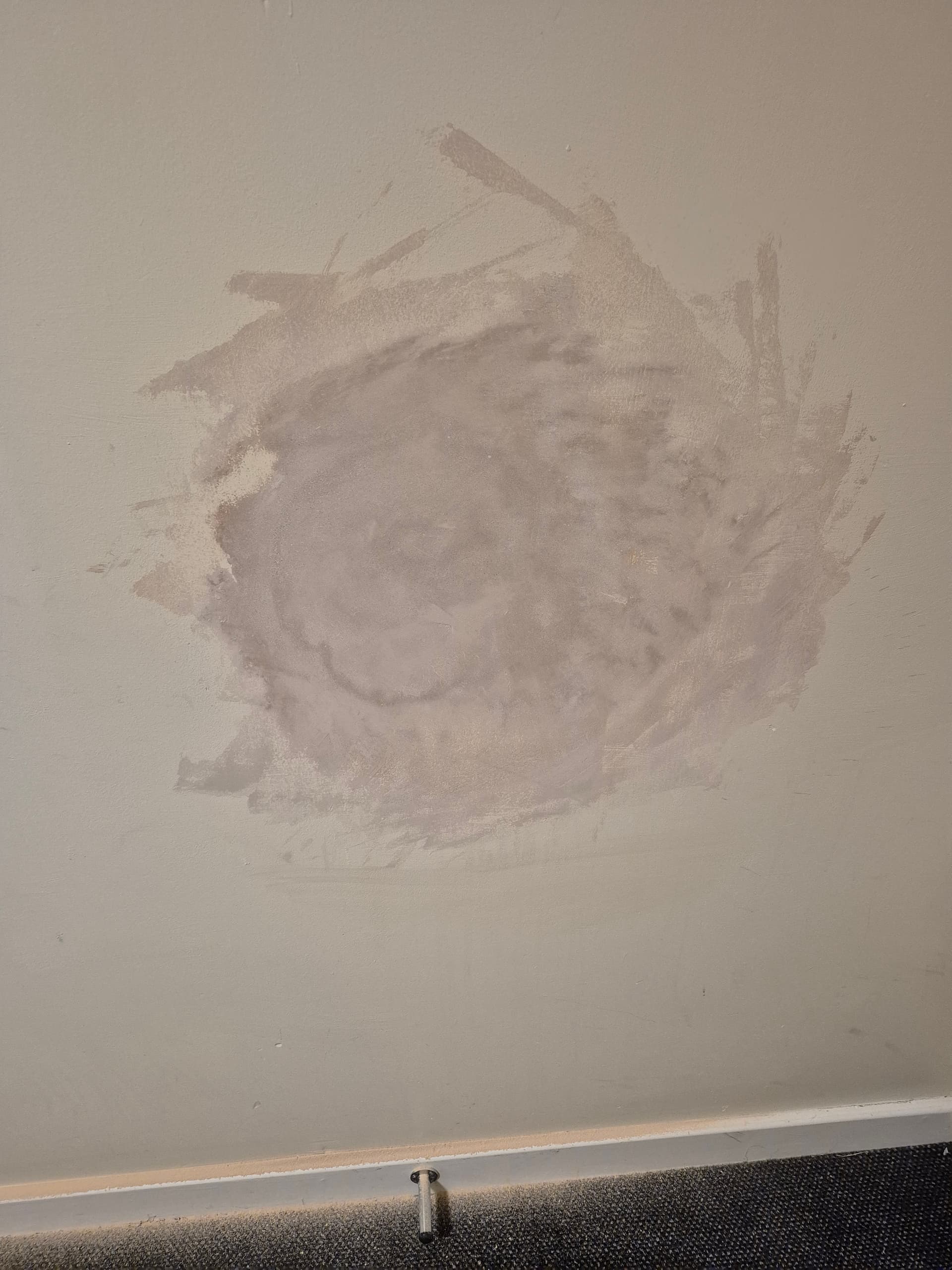 Plaster repair carried out on a damaged wall in a nearby home, filled, skimmed and smoothed to a clean finish.