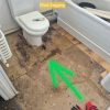 Before Sagged rotting T&G floorboards around bathroom plumbing fixtures during a repair project at Hansard Close Norwich.