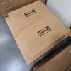 Heavy plain brown cardboard packing boxes containing a multi-unit IKEA PAX wardrobe storage system waiting to be assembled