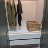 Completed white IKEA PAX wardrobe with matte grey-green GRIMO panel doors standing fully assembled on a job in Norwich