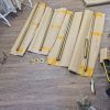 Unboxed galvanized steel tubes and wall flanges of a Klamp City corner changing room rail laid out flat Surrey Street