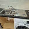 Old kitchen tap to be taken out with a new mixer faucet laid out ready for a replacement job at Morgan House in Norwich