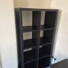 Completed black IKEA Kallax shelving unit standing fully assembled against a neutral wall for a home project in Norwich