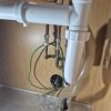 Existing water supply pipework under kitchen sink before alterations