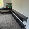 Six completed VOGREX console tables placed next to each other wrapped around a living room corner during a job