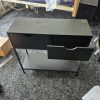 Completed VOGREX console table with a wooden top and black metal frame standing fully assembled for living room