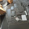 Flat pack components fixings and assembly instructions for a VOGREX hallway desk neatly organized on a floor