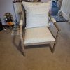 Fully assembled Hemingford armchair with beige textured fabric cushions, washed oak frame and decorative bobbin-style legs