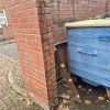 Brick wall after removal of the rotten wooden gate post, showing the original fixing area ready for a replacement timber post.
