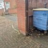 Old wooden gate post showing signs of rot and deterioration while still attached to a brick wall before replacement in Catton Grove.